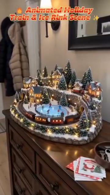 Another flat wreath on the door? Cute. Guests forget it in 3 seconds. This little village? They lean in and go “wait… is the train movi