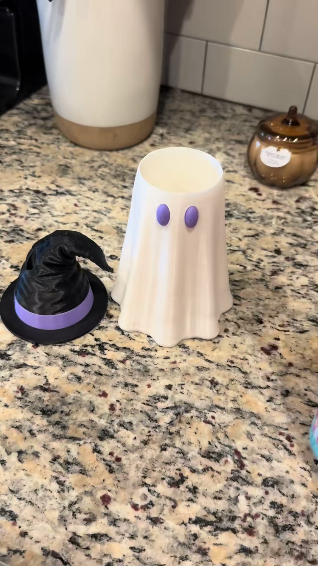 Dress up your drinks in style with our playful ghost witch hat cover.