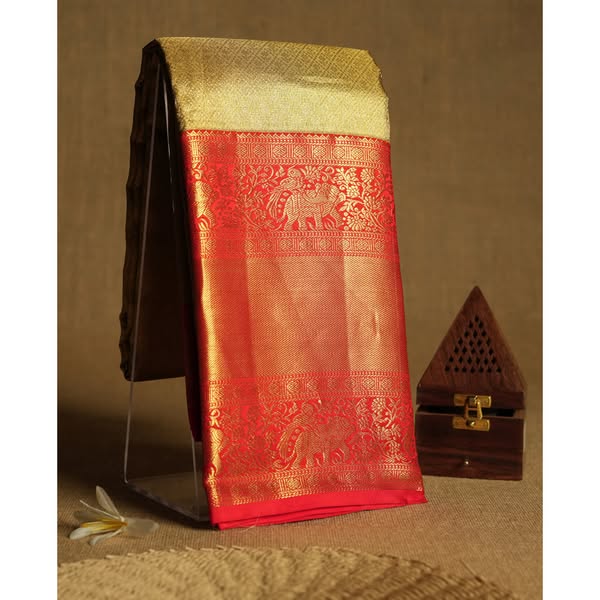 German Blue semi-Banaras tussar georgette saree adorned with antique zari butta motifs on the body, accentuated by a beautifully crafted jun
