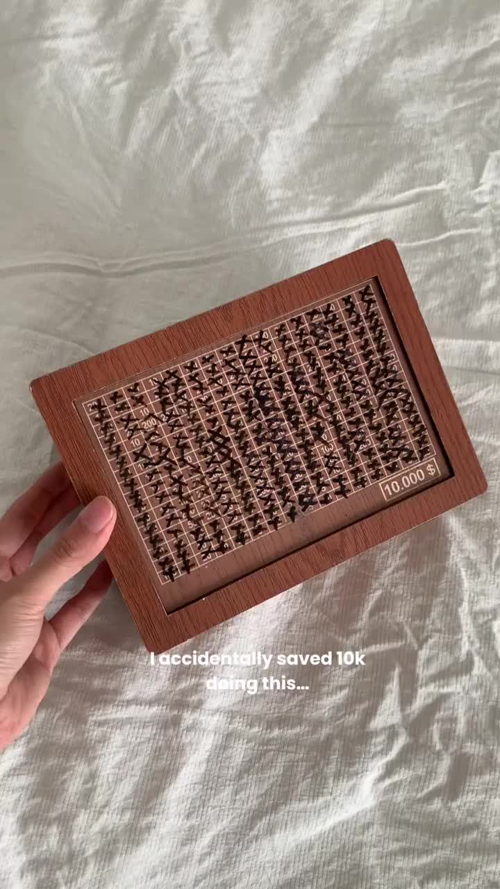 Wooden money box with engraved figures News