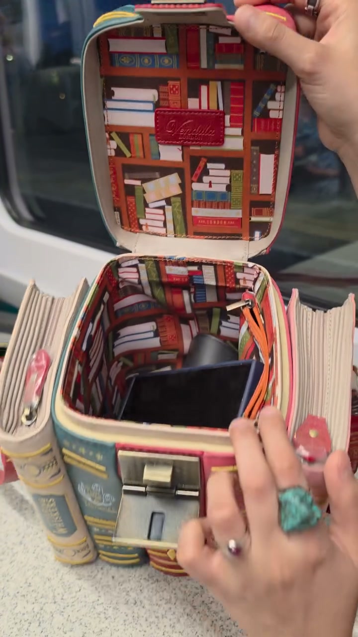 A stack of vintage novels. A library you can carry. Your outfit just got a PhD in style.